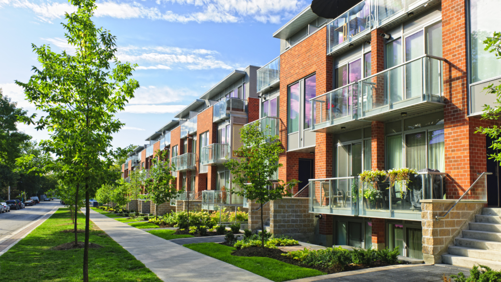 a row of apartment buildings on a sunny day