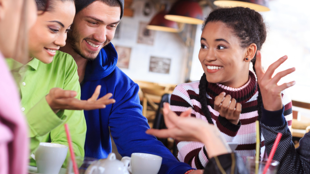 a group of people sitting at a table in a cafe