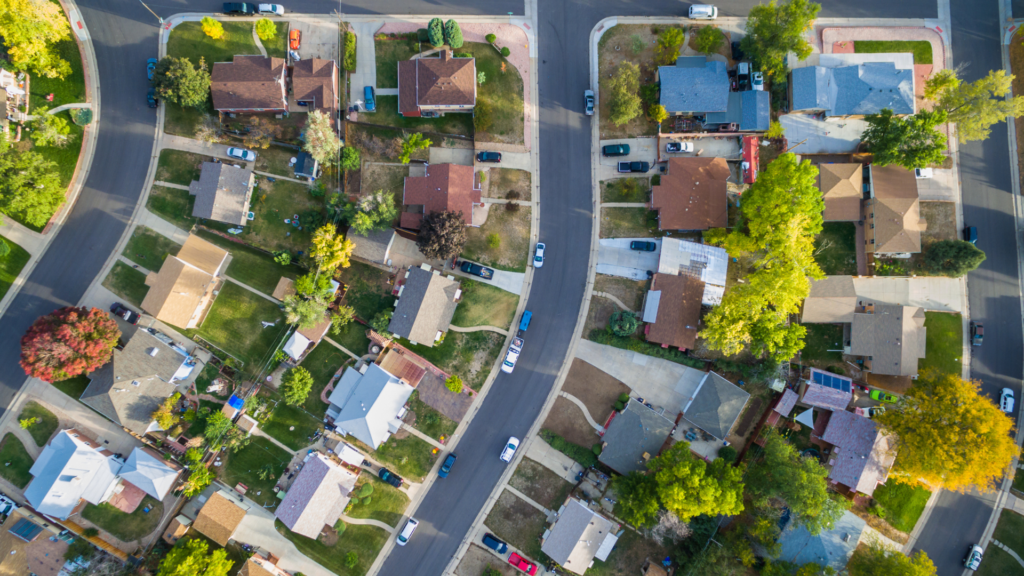 an aerial view of a neighborhood with houses and trees