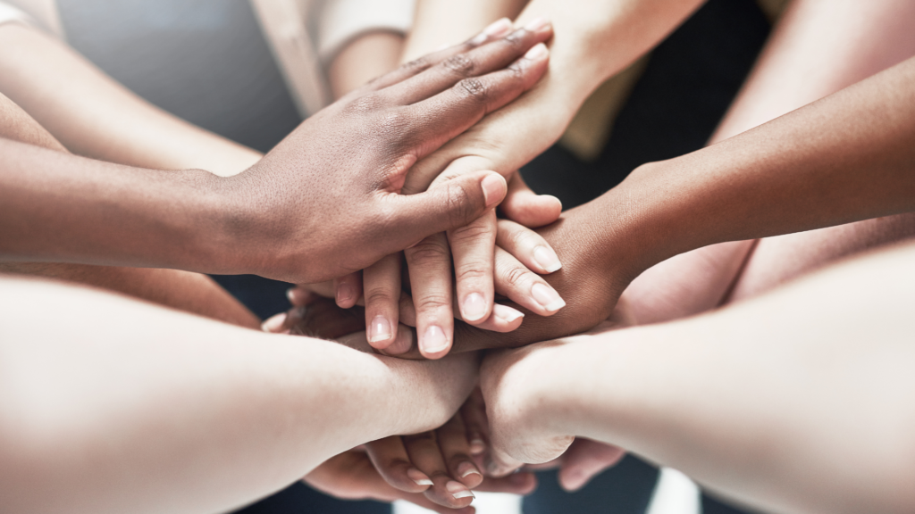 Group of people putting their hands together